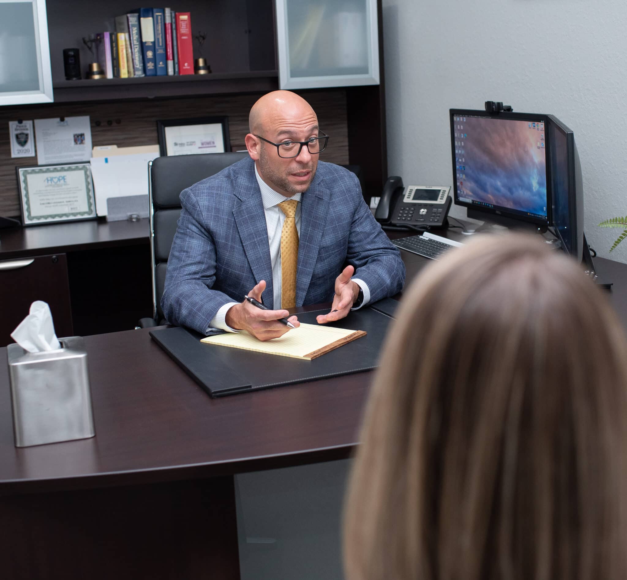 attorney Brian D. Tadros talking with a client