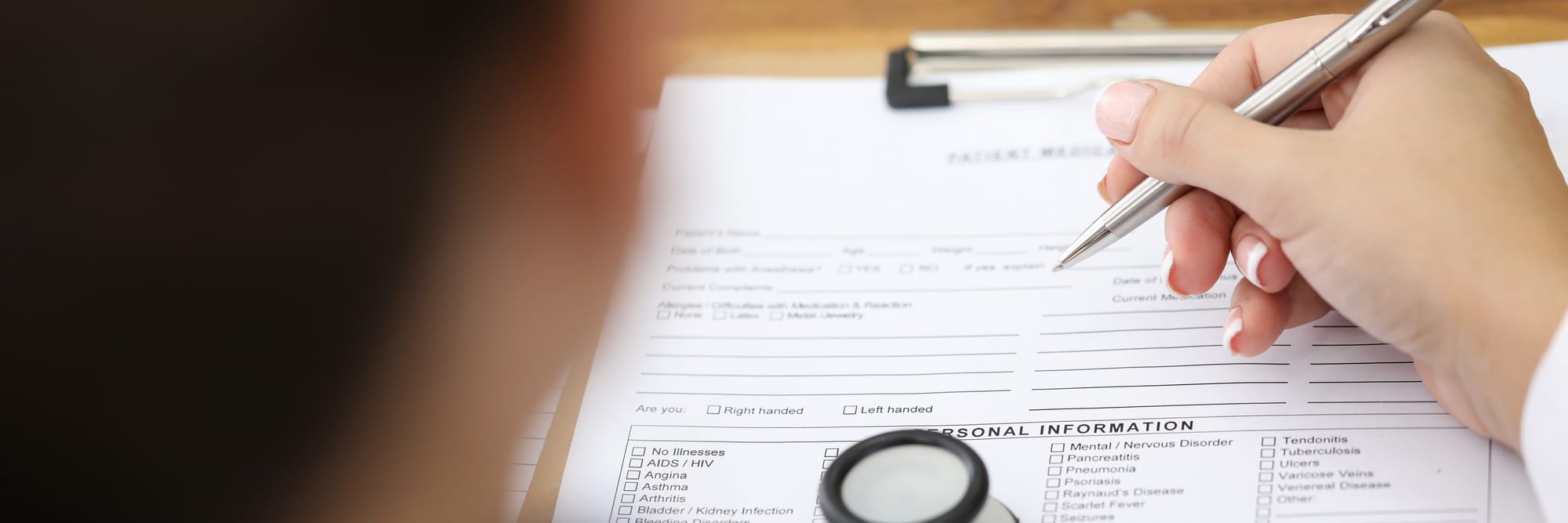 woman filling out paperwork with medical information
