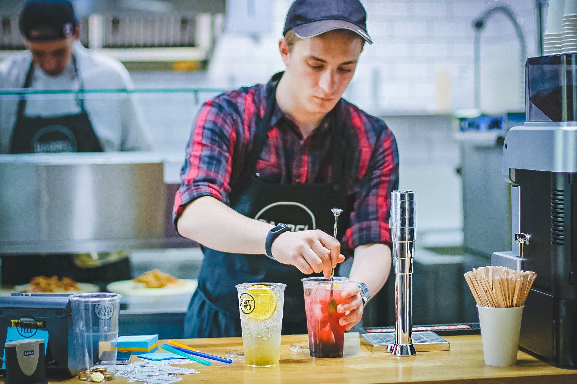 young man mixing drink in a commercial kitchen